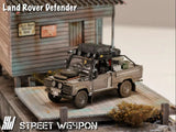Land Rover Defender *Tomb Raider* Muddy - Street Weapon - 1:64 Modellauto 1/64