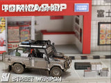 Land Rover Defender *Tomb Raider* Muddy - Street Weapon - 1:64 Modellauto 1/64